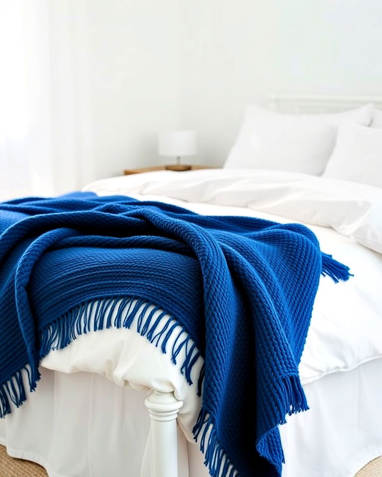 stylish blue throw blanket on white bed - 25 Blue and White Bedroom Ideas