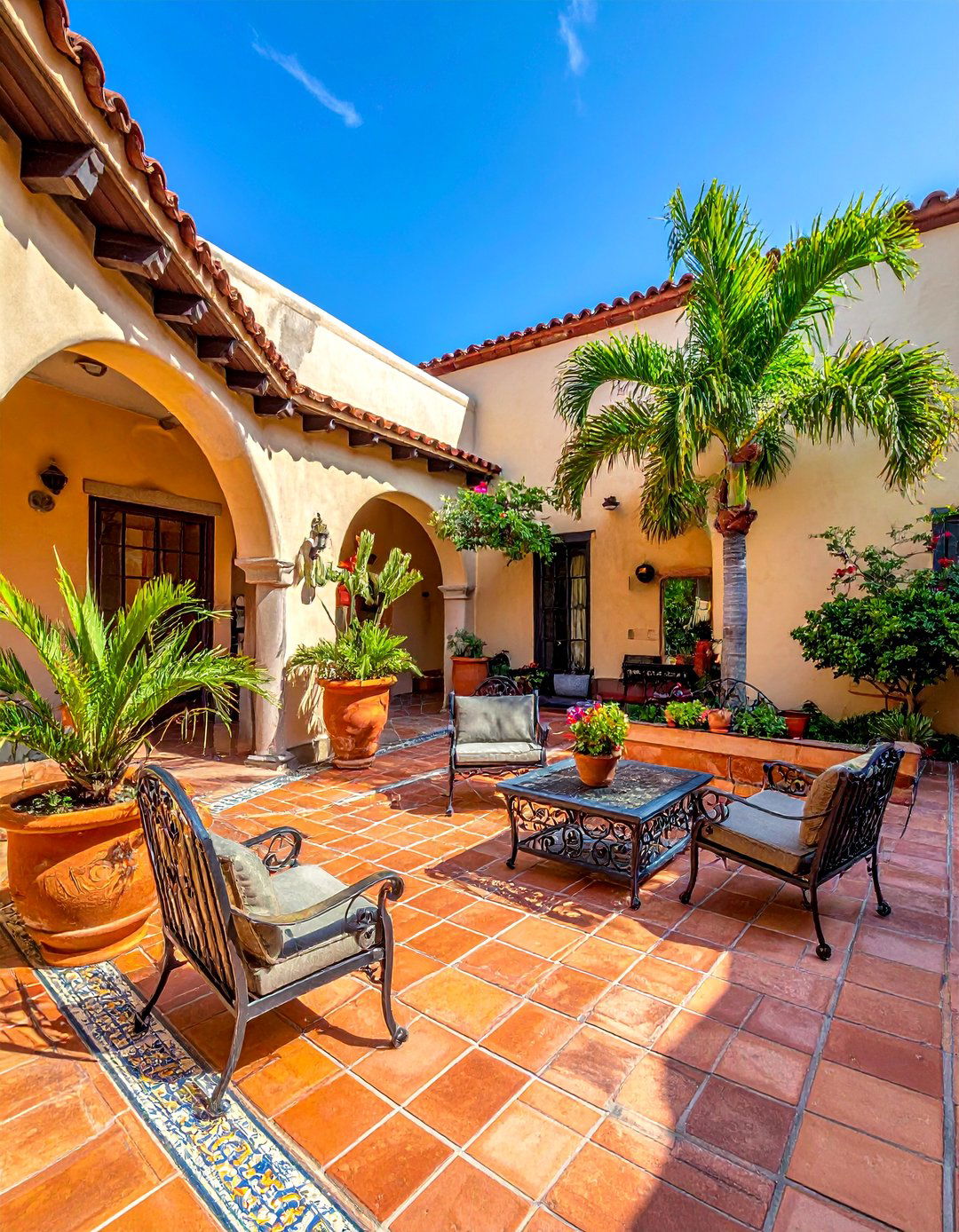 A Classic Saltillo Tile Patio in a Mexican Garden - 25 Mexican Garden Ideas for a Vibrant Outdoor Space