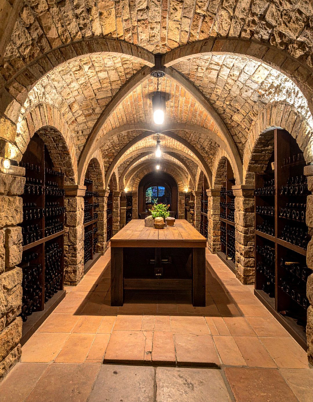 A Wine Cellar with Stone Archways - 25 Gothic Castle Ideas for a Dramatic and Unique Home