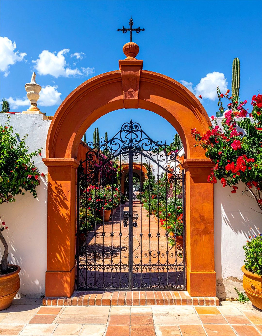 A Wrought Iron Gate in a Mexican Garden - 25 Mexican Garden Ideas for a Vibrant Outdoor Space