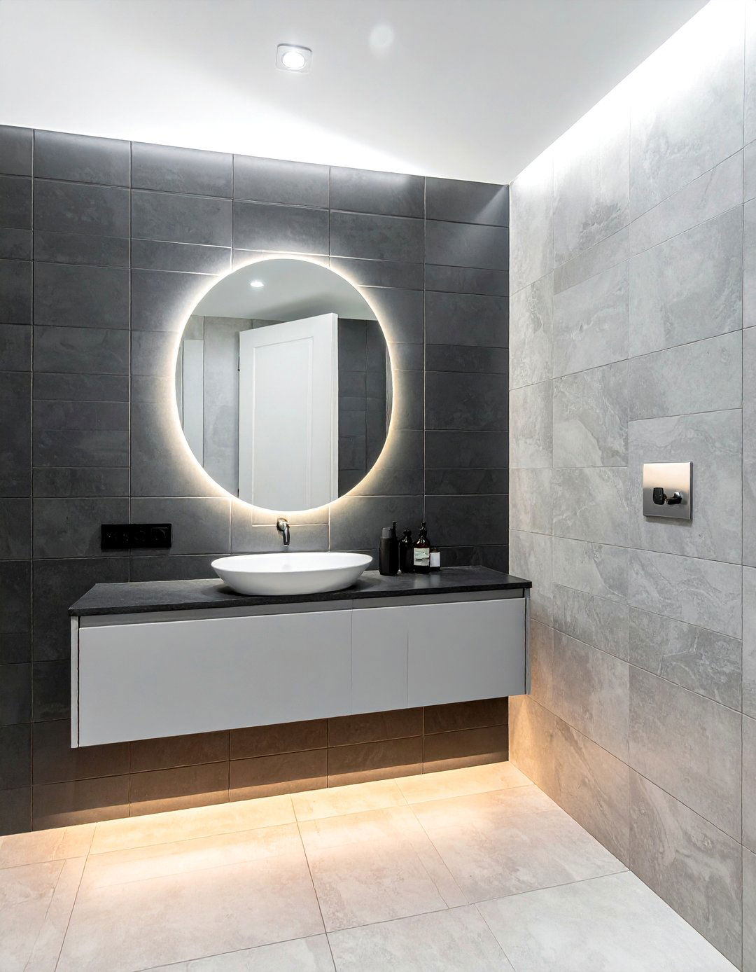 A Backlit Mirror Over a Grey Tiled Wall - 20 Black and Grey Bathroom Ideas for a Stylish Retreat