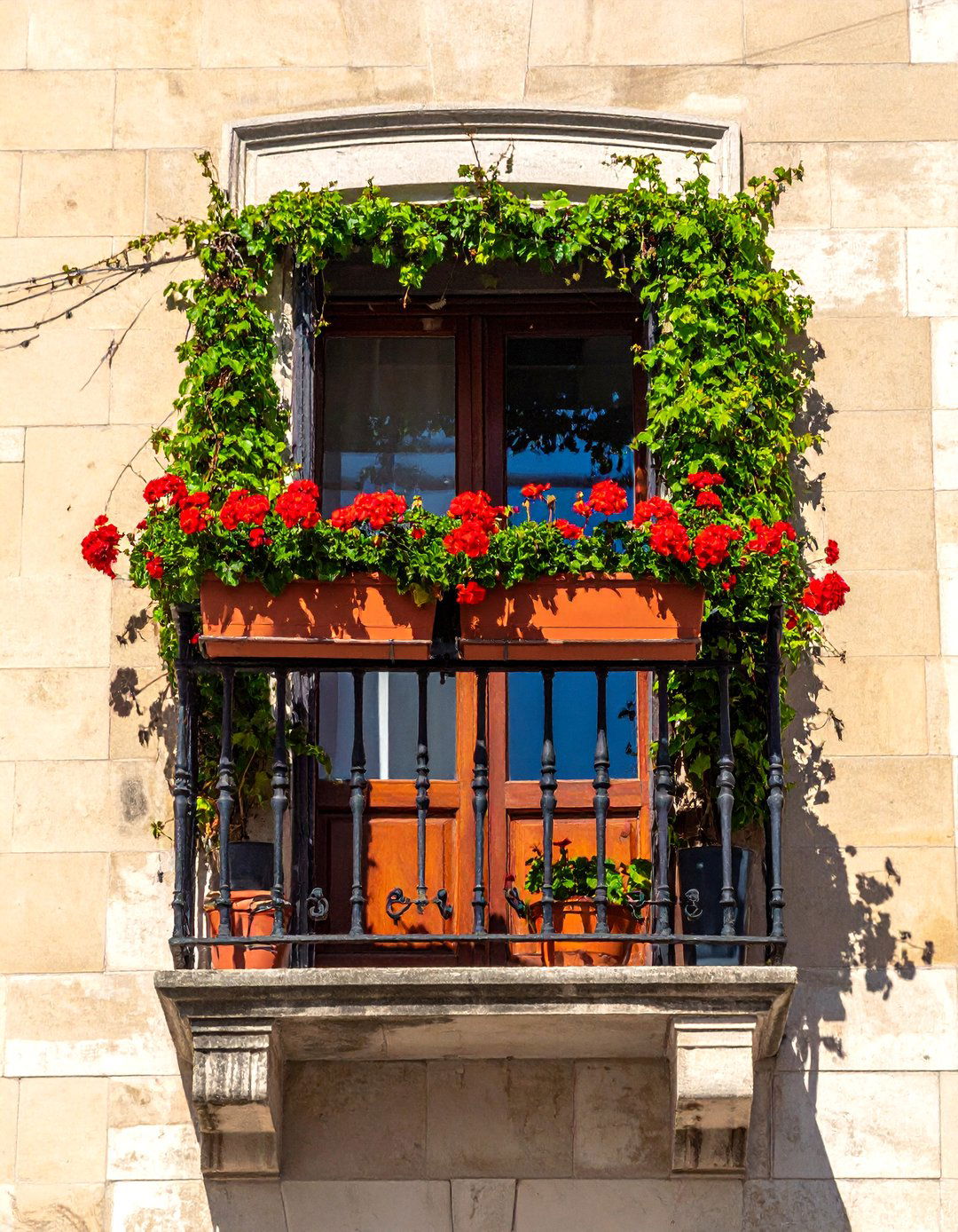 A French Balcony with Cascading Flower Boxes - 25 French Balcony Ideas for a Charming Outdoor Space