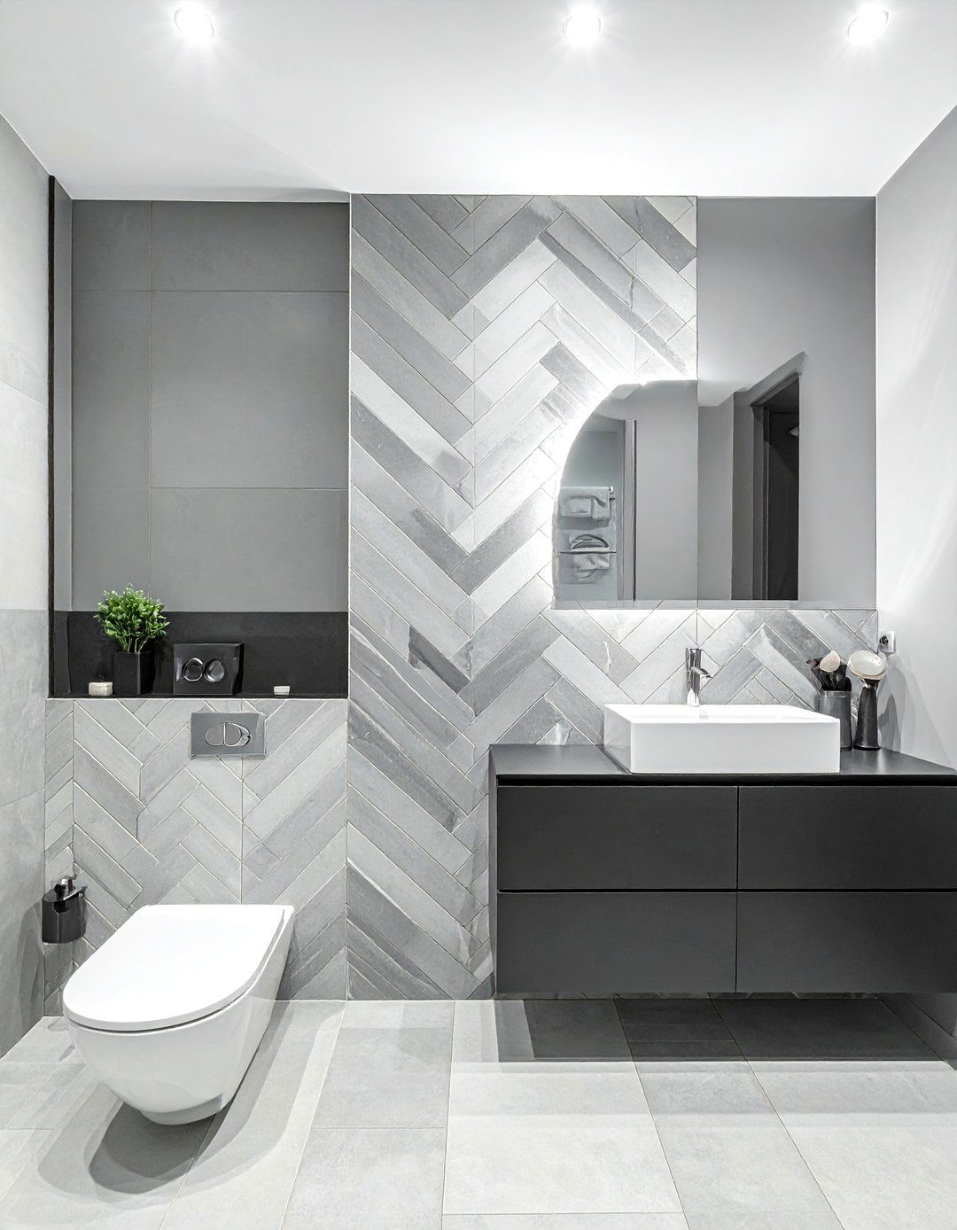A Grey Herringbone Tile Accent Wall - 20 Black and Grey Bathroom Ideas for a Stylish Retreat