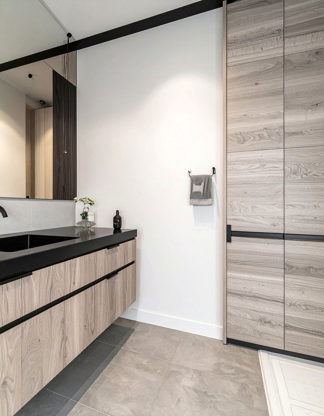 A Grey Wood Vanity with a Black Stone Countertop - 20 Black and Grey Bathroom Ideas for a Stylish Retreat