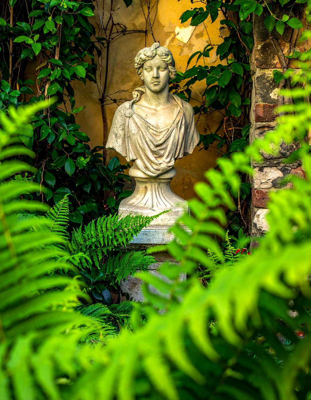 An Italian Backyard with Antique Style Statuary - 20 Italian Backyard Ideas for a Mediterranean Oasis