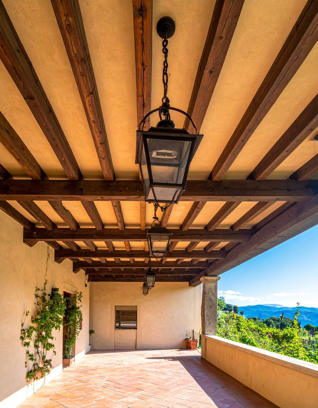 An Italian Patio with Exposed Wooden Beams - 20 Italian Patio Ideas for a Mediterranean Outdoor Oasis