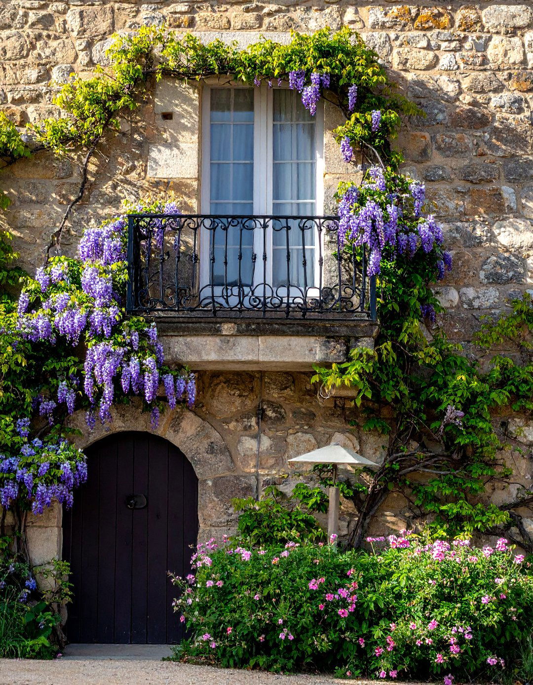 French Balcony Integrated with Climbing Vines - 25 French Balcony Ideas for a Charming Outdoor Space