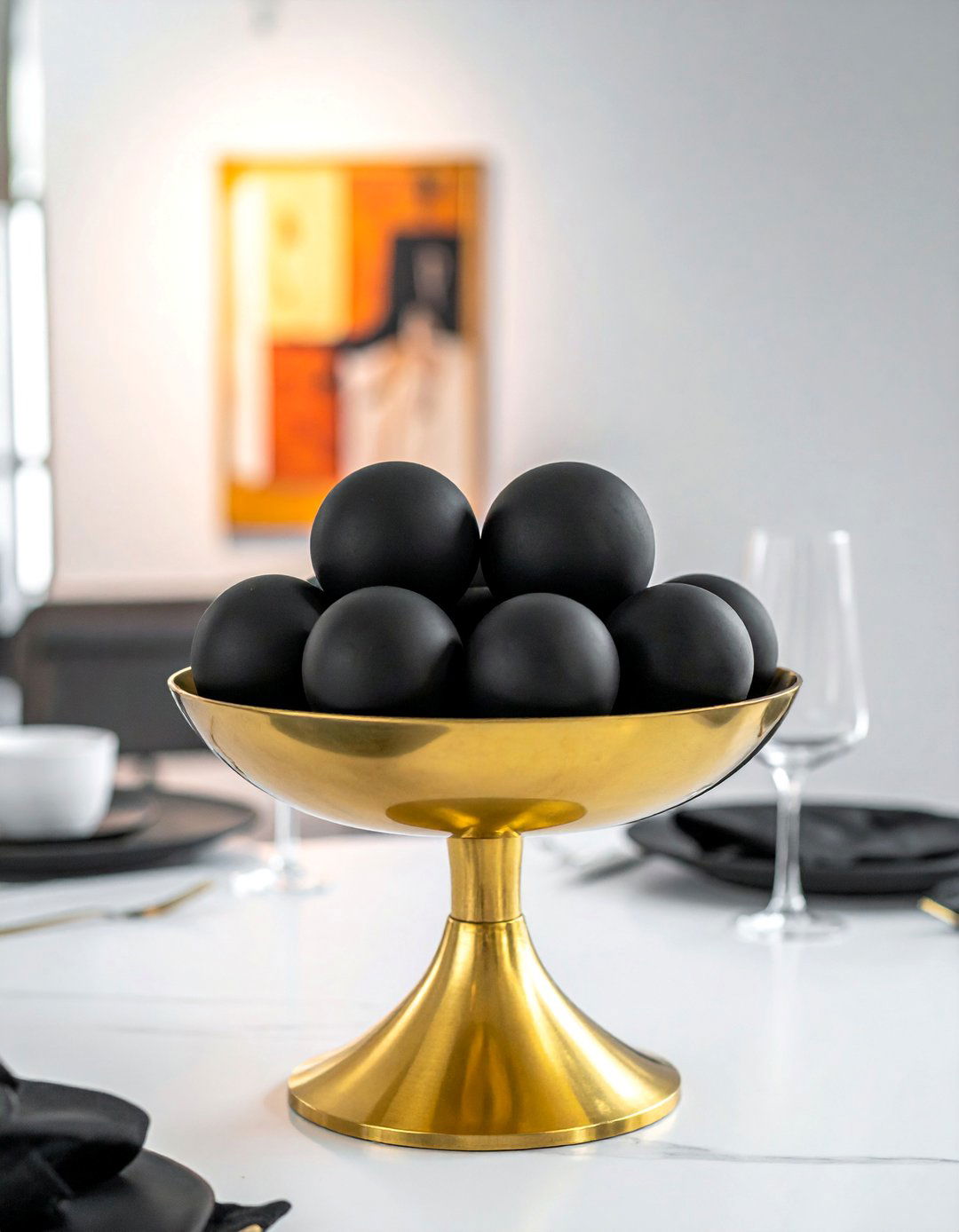 Gold Pedestal Bowl with Black Orbs Centerpiece - 20 Black and Gold Centerpiece Ideas for Elegant Tables