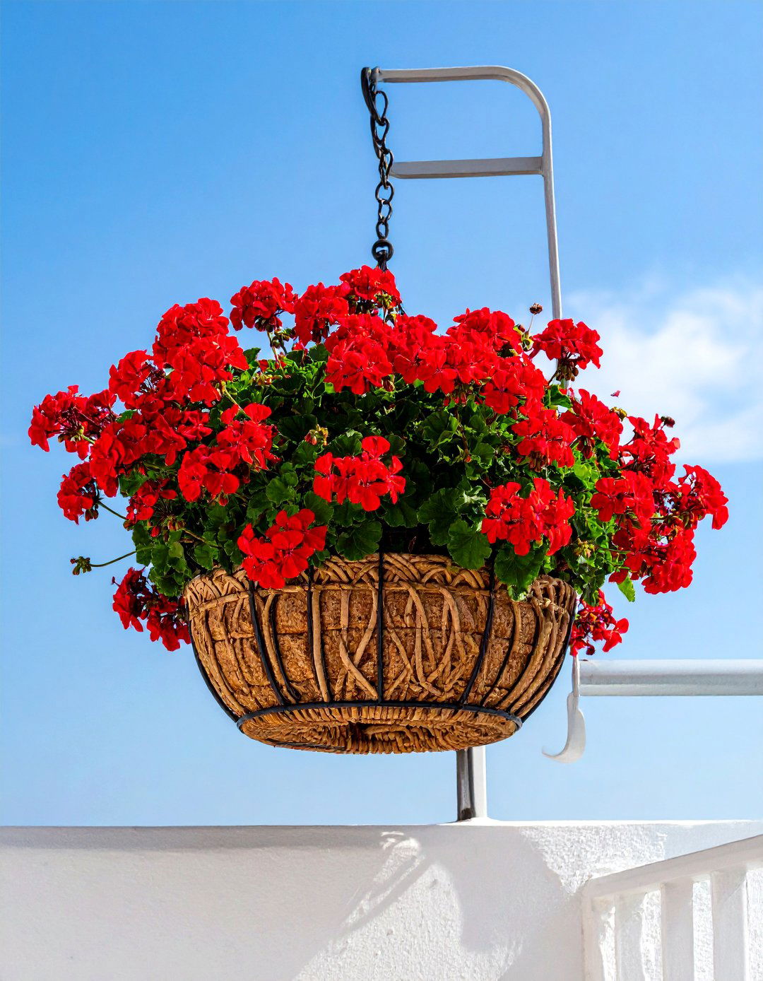 Hanging Geranium Baskets on a Mediterranean Balcony - 20 Mediterranean Balcony Ideas for a Scenic Escape