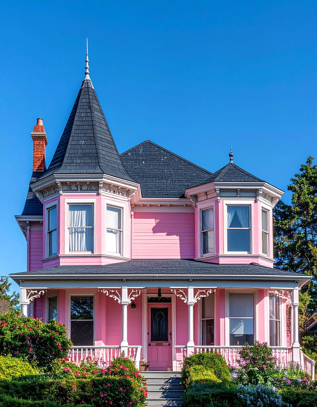 Pink Victorian House with a Dark Gray Roof - 25 Pink Victorian House Ideas for a Charming Home