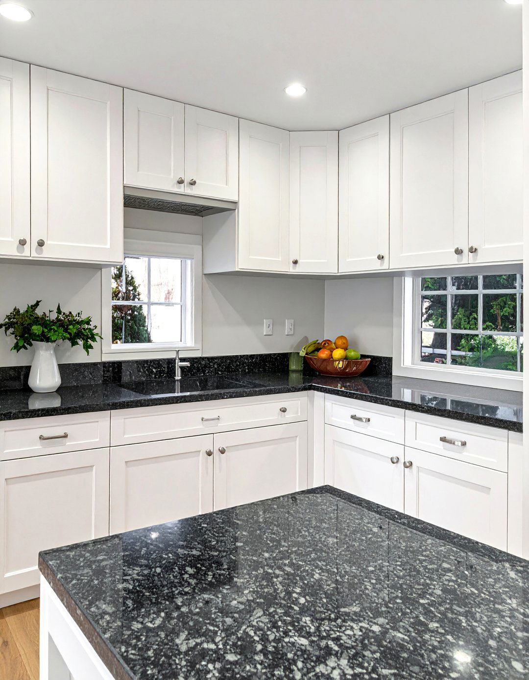 White Shaker Cabinets with Polished Black Granite Countertops - 40 White Kitchen Ideas with Black Countertops
