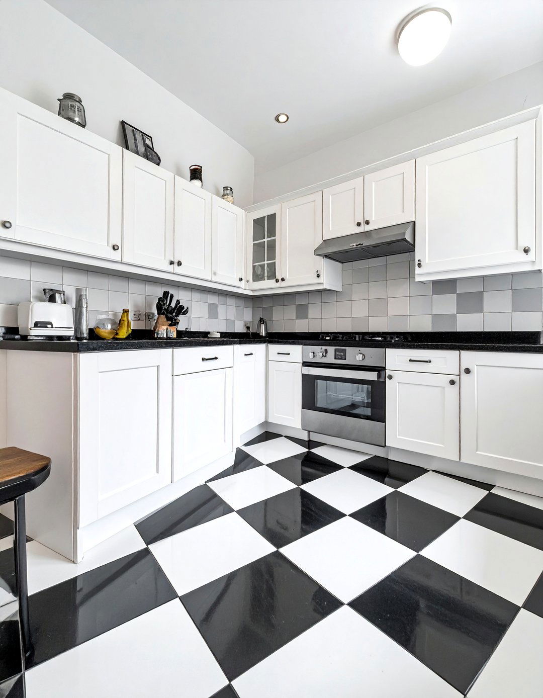 Black and White Kitchen with a Checkerboard Floor - 40 Black and White Kitchen Ideas for a Classic and Chic Space