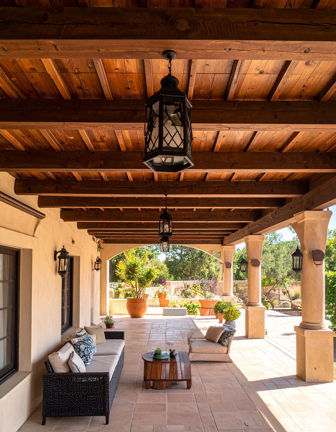 Mediterranean Patio Featuring Rustic Wooden Beams - 25 Mediterranean Patio Ideas for a Relaxing Outdoor Space