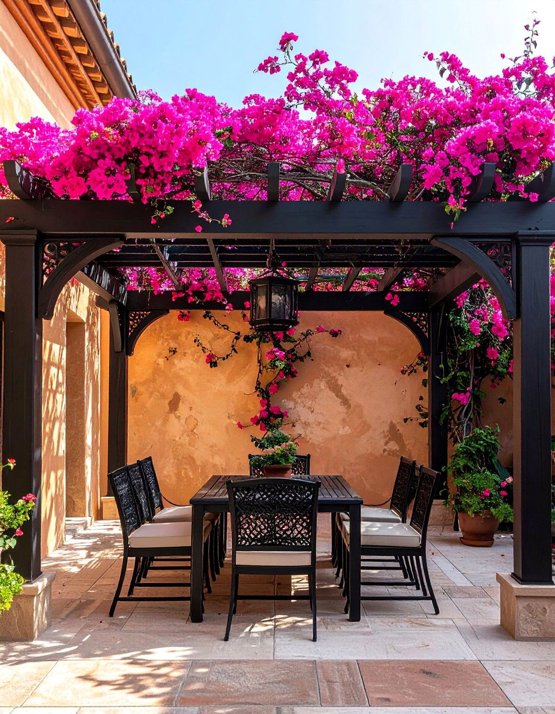 Mediterranean Patio with a Wrought Iron Pergola - 25 Mediterranean Patio Ideas for a Relaxing Outdoor Space