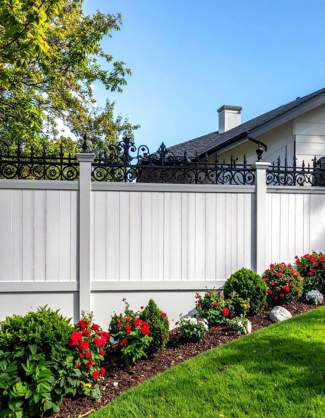 Wood Fence with Decorative Wrought Iron Toppers - 25 Metal and Wood Fence Ideas for Your Outdoor Space