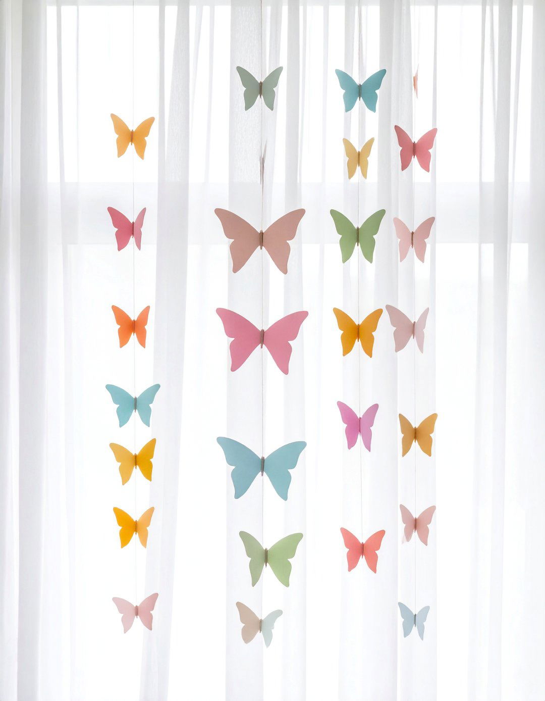 A DIY Hanging Paper Butterfly Garland - 15 Butterfly-themed Room Ideas for a Whimsical Space