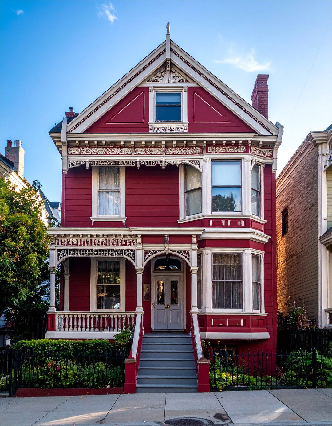 Dark Red Victorian House with Intricate White Detailing - 20 Dark Red House Exterior Ideas for Bold Homes