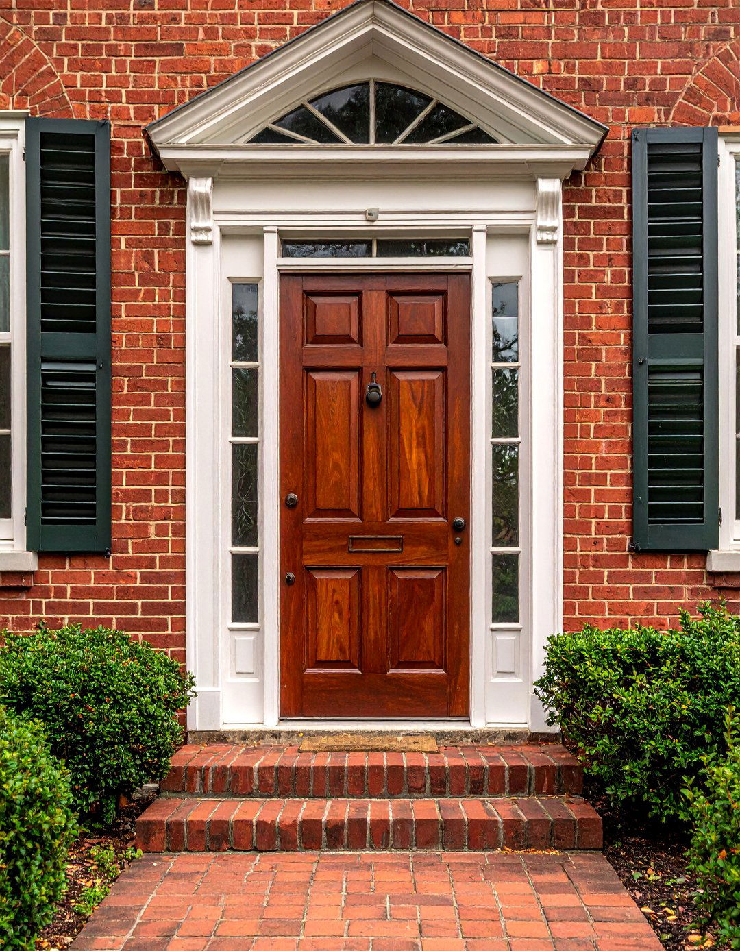 Jacobean Stained Front Door on a Brick Facade - 25 Elegant Stained Front Door Ideas for Curb Appeal