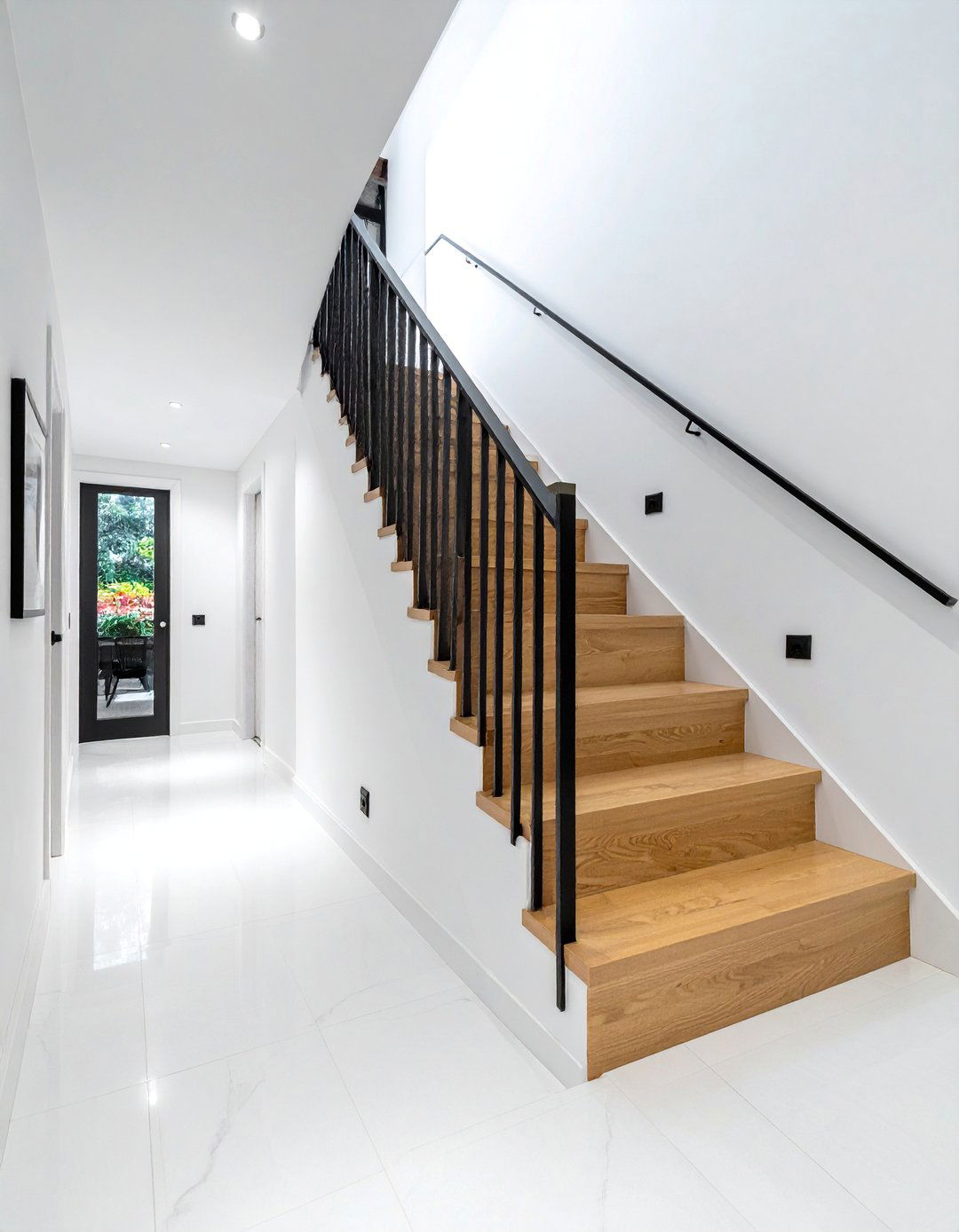 Modern Black Metal Spindle Staircase - 20 Black and White Hallway Ideas for a Modern Look