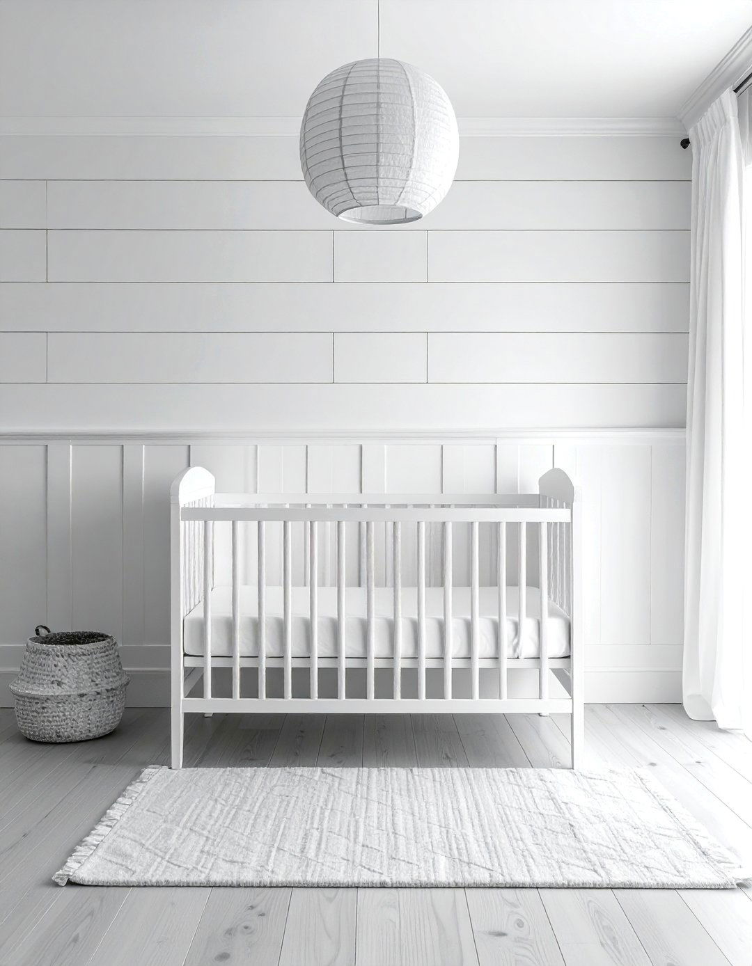 White Nursery Featuring a Textured Accent Wall - 15 White Nursery Ideas for a Calm and Serene Space