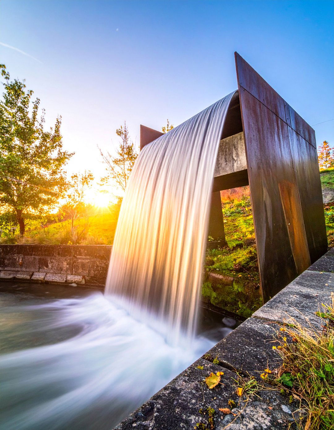 Industrial Metal Spillways - 25 Waterfall Design Ideas for a Serene Outdoor Space