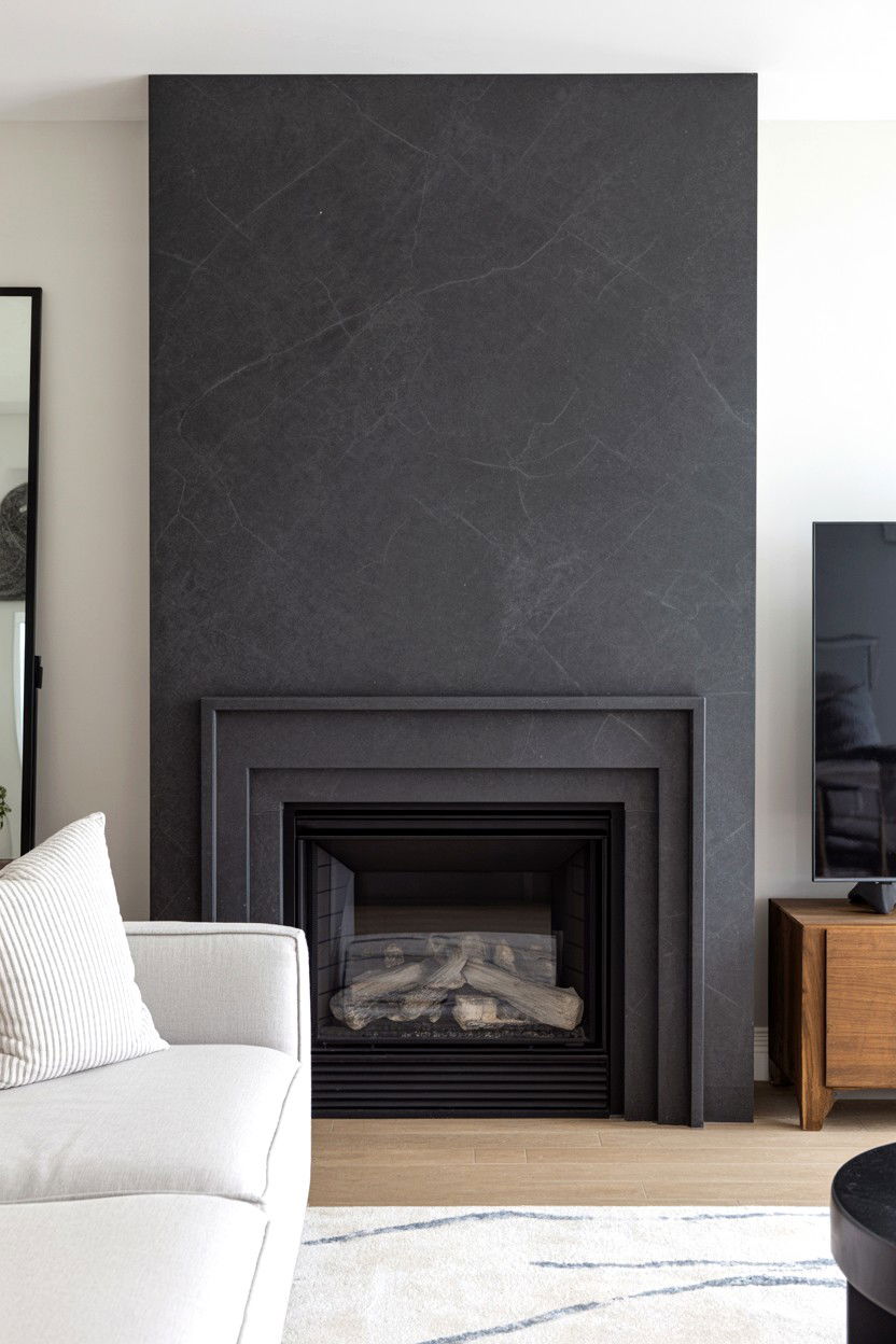 Black Quartz Composite Fireplace Surround with Consistent Color - 30 black fireplace wall ideas